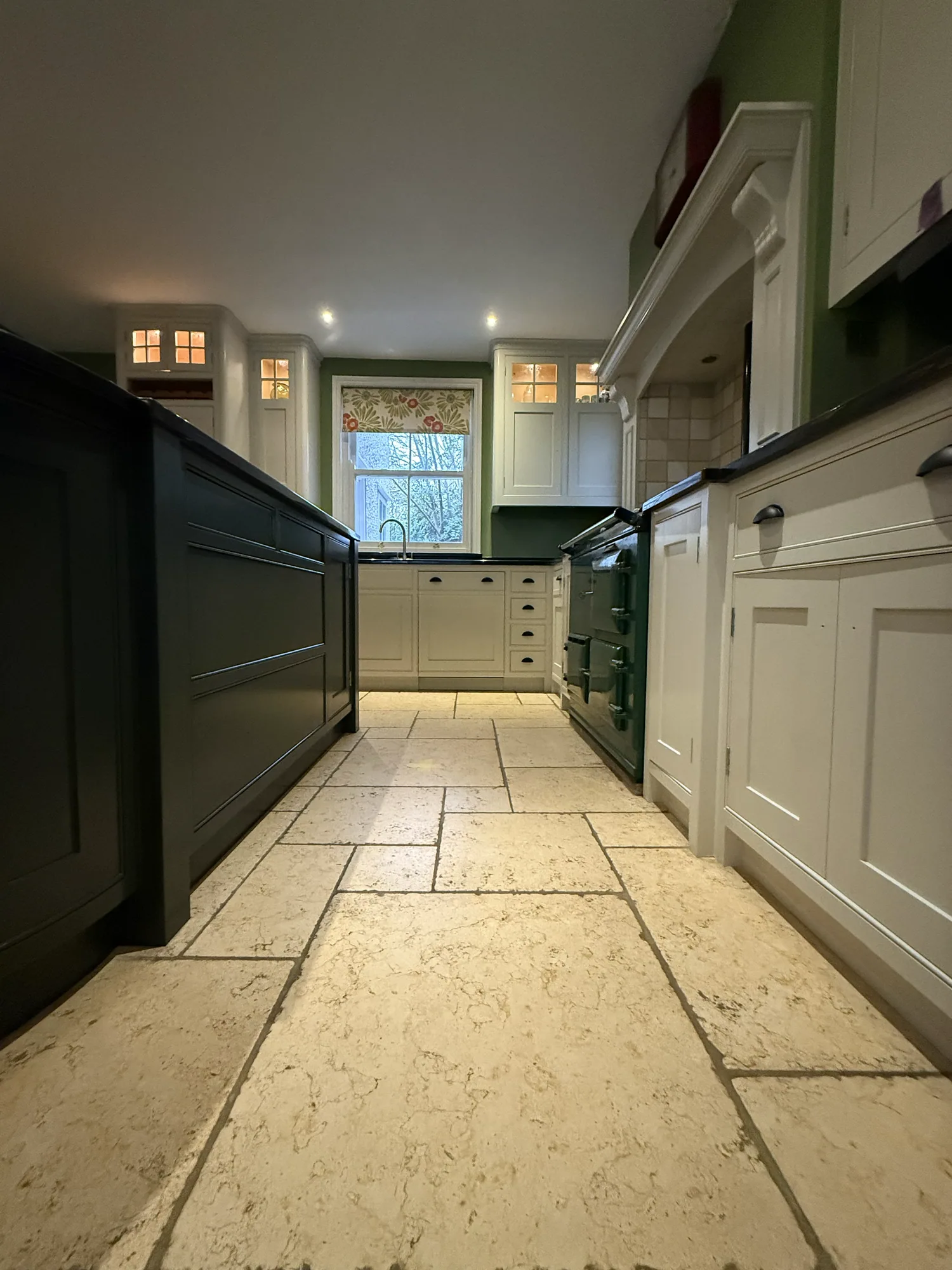 Galley kitchen resprayed in off white with a dark island