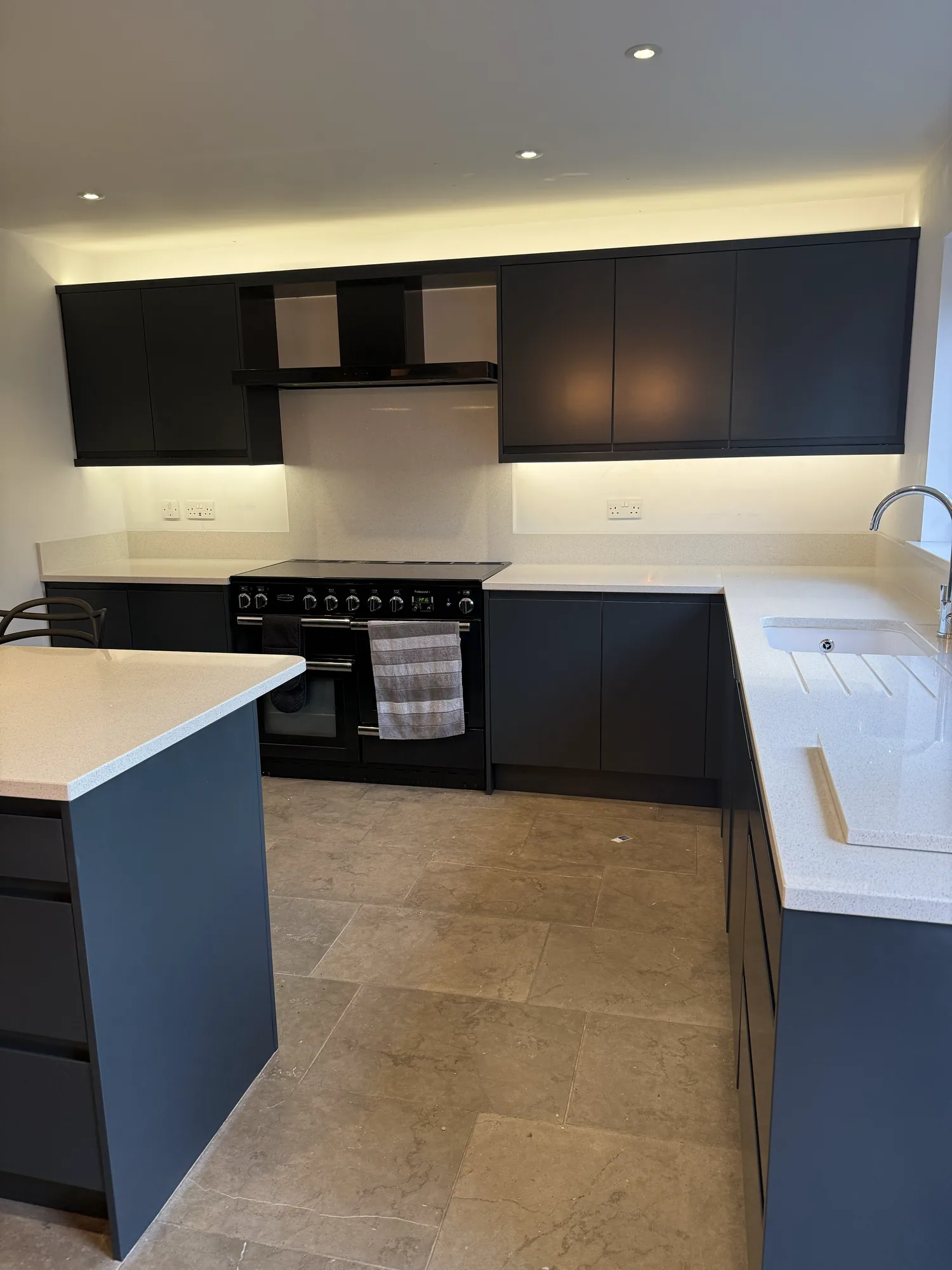 Navy and black kitchen resprayed around a range cooker
