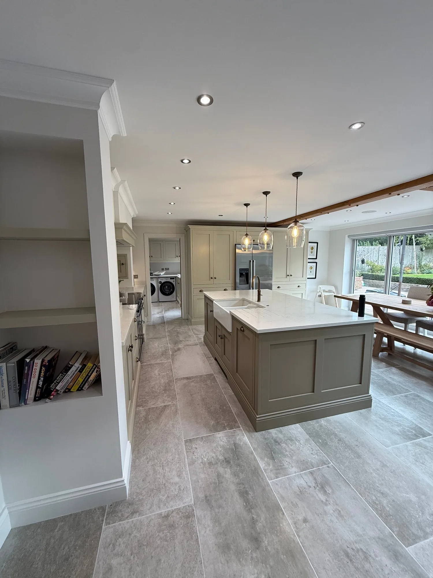 Pale grey kitchen island in an open plan room