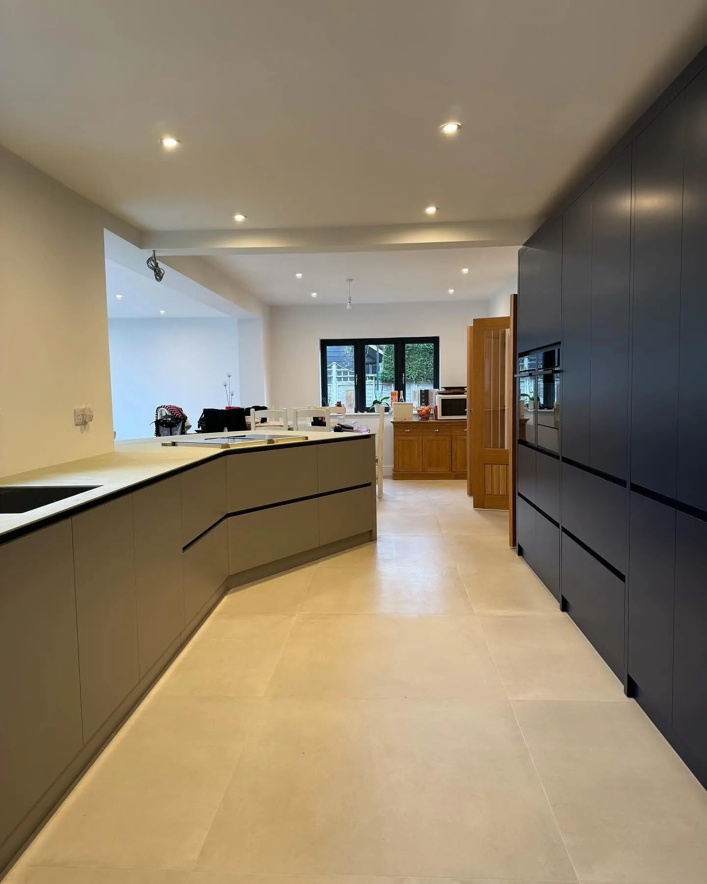Dark grey handleless kitchen in an open plan space