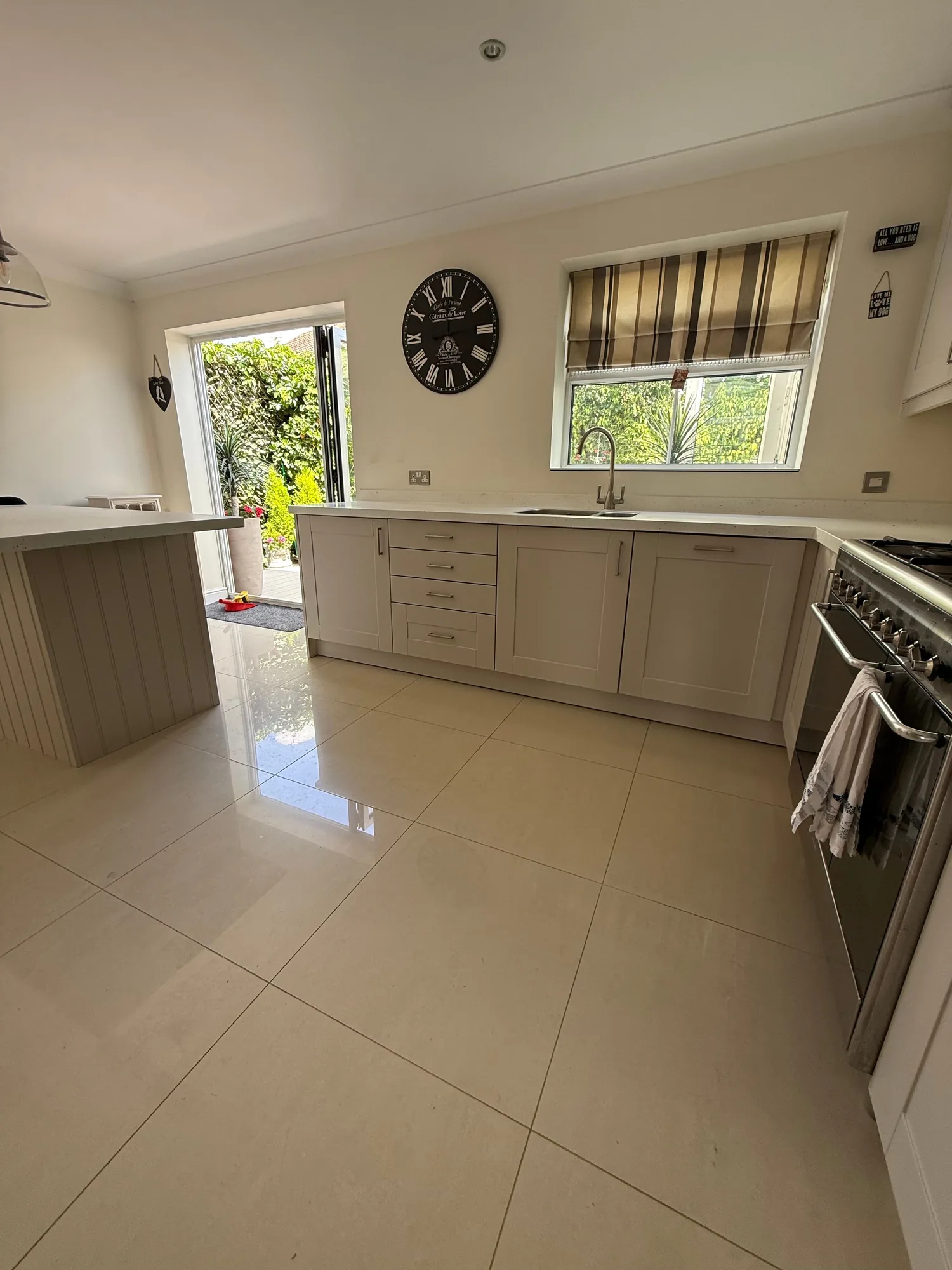 Cream kitchen with tiled floor and garden window